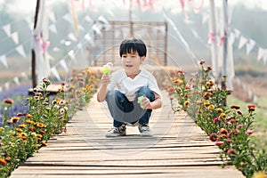 Asian children  boys enjoying blowing a soap bubbles