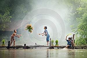 Asian children farmer on rice cross the wood bridge before the g