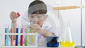 Asian children girl testing chemical in laboratory