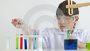 Asian children girl testing chemical in laboratory