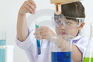 Asian children girl testing chemical in laboratory