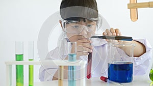 Asian children girl testing chemical in laboratory