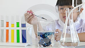 Asian children girl testing chemical in laboratory