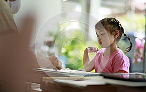 Asian children learning to drawning by pencil