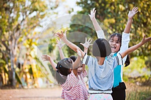 Asian children raise hands and playing together with fun