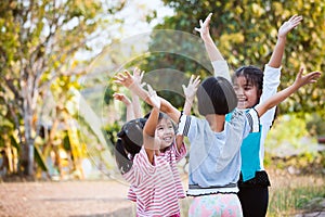 Asian children raise hands and playing together with fun