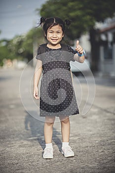 Asian children with school backpack hand sign good and toothy sm