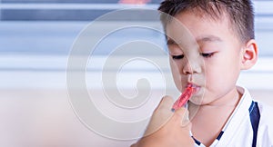 Asian children sick he take medicine by syringe