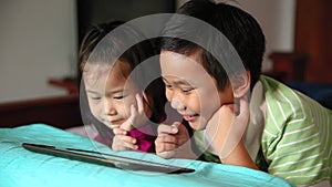 Asian children using digital tablet. E-learning concept.