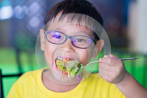 Asian children wear glasses with blue light blocking and eating