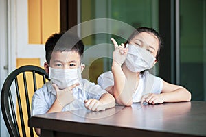 Asian children wearing protection mask study at home school