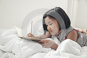 Asian Children Writing Letter on diary book