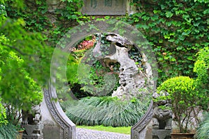 Asian Chinese ancient garden, beautiful landscape, stone archway.