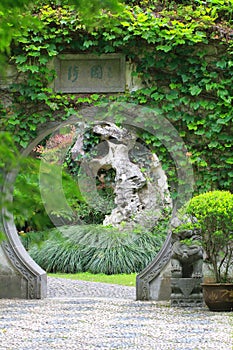 Asian Chinese ancient garden, beautiful landscape, stone archway.