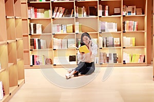 Asian Chinese beautiful pretty cute woman girl student Teenager read book in bookstore library