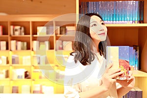 Asian Chinese beautiful pretty young cute woman girl student Teenager read book in bookstore library smile spend her pastime