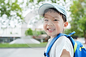 Asian Chinese boy in backpack and blue cap