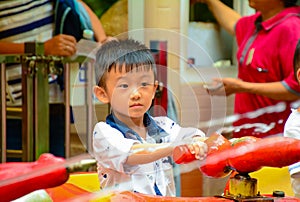 Asian Chinese boy playing with water spray