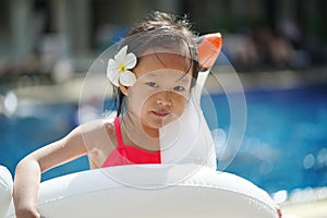 Asian chinese child with her float at a swimming pool