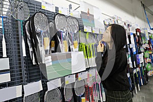 Asian chinese choosing Badminton racket , Badminton racket area in Decathlon store