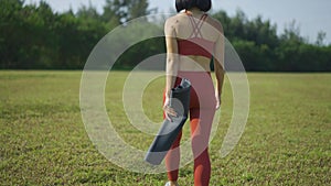 Asian chinese female yoga yogi walking in morning sun singapore