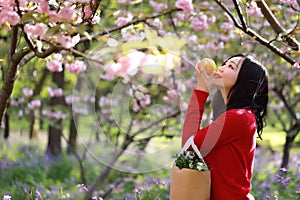 Asian Chinese freedom woman smiling and smell fruit in nature in spring outdoor