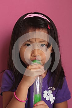 Asian Chinese Girl eating Ice Pop