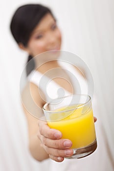 Asian Chinese Girl Holding Glass of Orange Juice