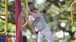 Asian chinese girl overcoming difficult outdoor obstacles alone