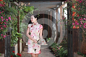 Asian Chinese girls wears cheongsam enjoy free time in ancient town photo