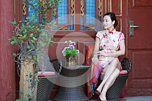 Asian Chinese girls wears cheongsam enjoy holiday in lijiang ancient town