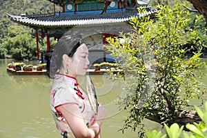 Asian Chinese girls wears cheongsam enjoy holiday in lijiang ancient town photo