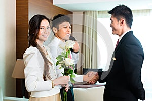 Asian Chinese hotel manager welcome VIP guests photo