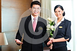 Asian Chinese hotel manager welcoming VIP guests photo