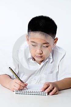 Asian Chinese Little Boy Wearing Student Uniform Writting Homework