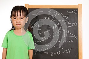 Asian Chinese little girl againts blackboard with formulas