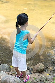 Asian Chinese little girl angling with fishing rod