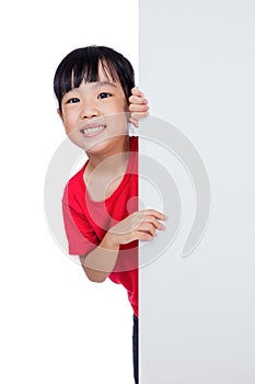 Asian Chinese little girl behind a blank white board