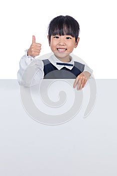 Asian Chinese little girl behind a blank white board