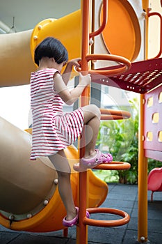 Asian Chinese little girl climbing stepladder