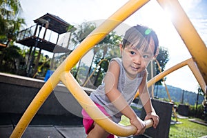 Asian Chinese little girl climbing stepladder