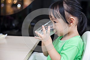 Asian Chinese little girl drinking beverage