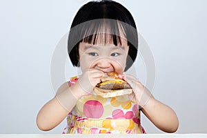 Asian Chinese little girl Eating Burger