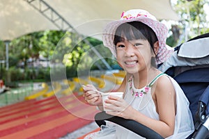 Asian Chinese little girl eating ice cream