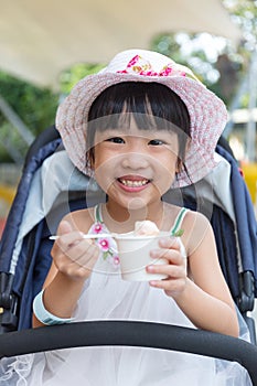 Asian Chinese little girl eating ice cream