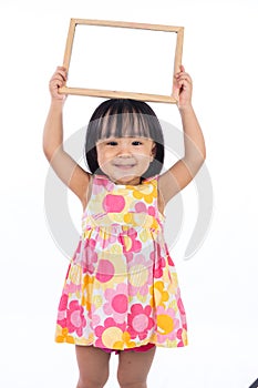 Asian Chinese little girl holding blank whiteboard