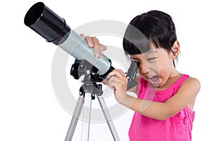 Asian Chinese little girl holding a telescope
