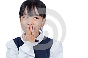 Asian Chinese little girl laughing and covering her mouth