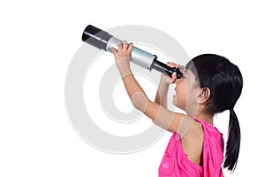 Asian Chinese little girl looking through a telescope