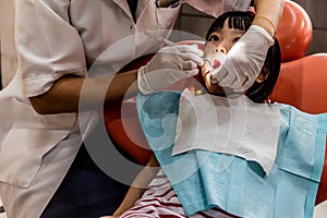 Asian Chinese little girl lying down for tooth extraction